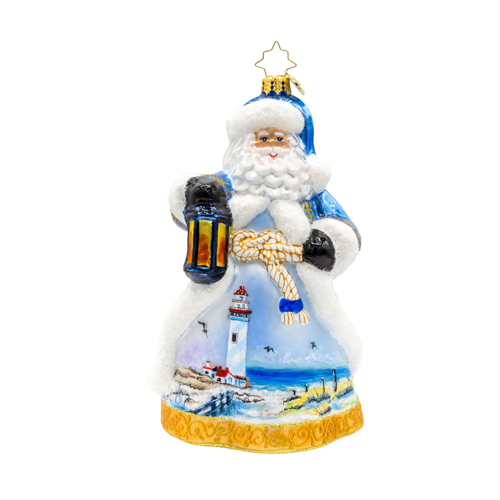 Coastal Claus ornament. Santa dons a blue robe with hand painted lighthouse scene. View of front.