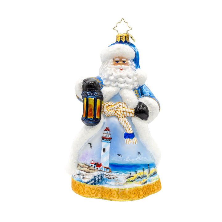 Coastal Claus ornament. Santa dons a blue robe with hand painted lighthouse scene. View of front.