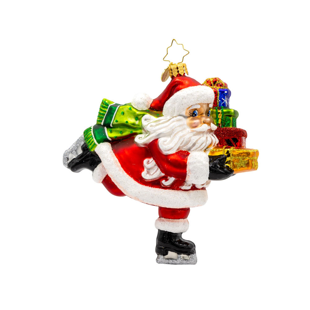 Dashing Through The Ice ornament. Santa is seen ice skating with a stack of gifts in hand. View of front. 