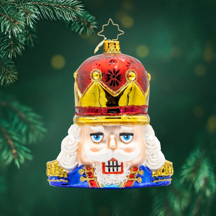 Nutty Noel ornament. This nutcracker seen from the shoulders up, where's a crown of red and gold. View of front. 