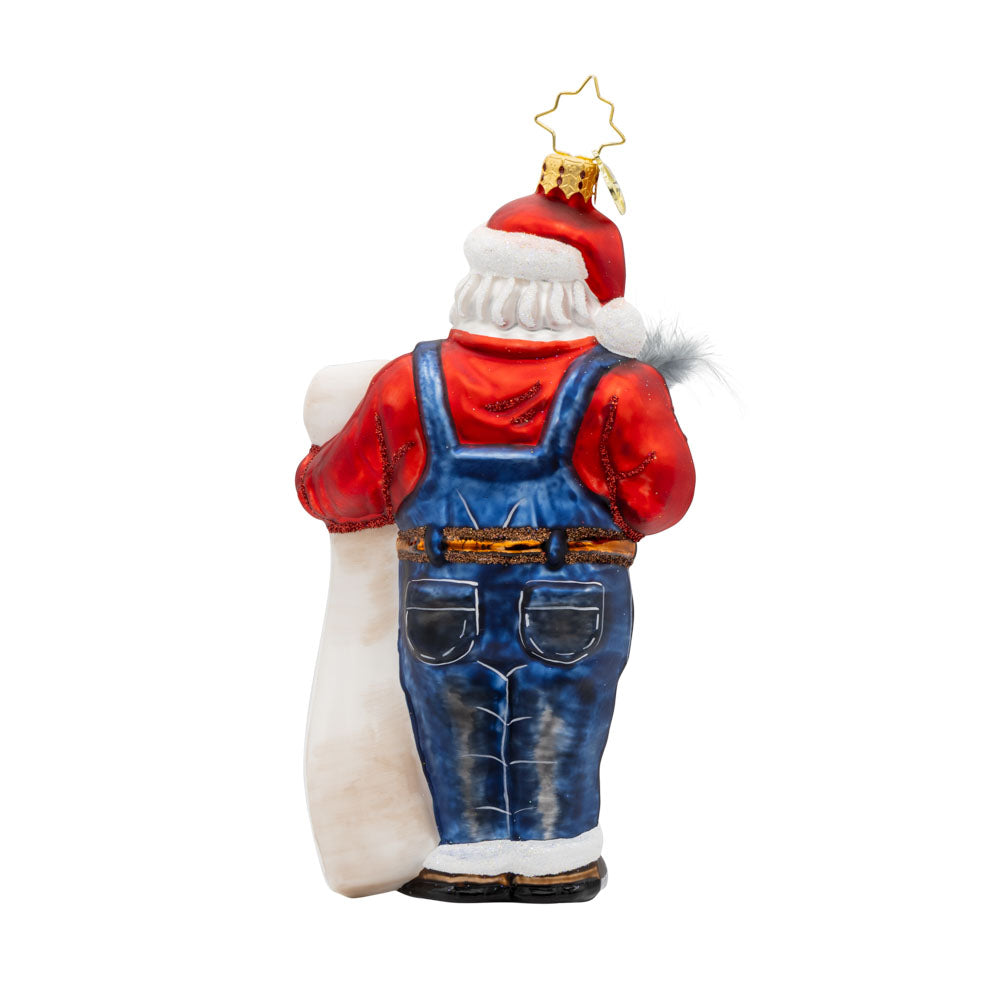 Santa's Holiday Roll Call ornament. Santa is wearing blue work overalls and is holding a long list of toys with quill in hand. View of back.