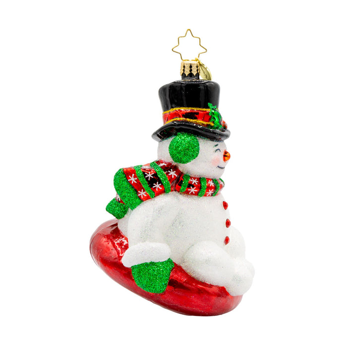 Snowy Slider ornament. This snowman is bundled up with a top hat sitting on a red innertube. View of left side.