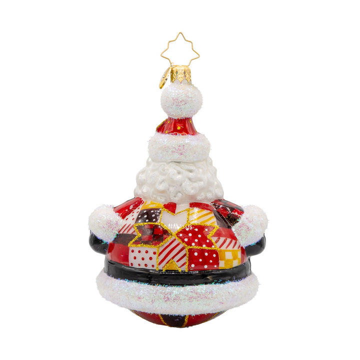 Quilted Jolly Claus ornament. Santa is dressed in a cozy patchwork quilt with shiny buttons and a festive hat. View of back.