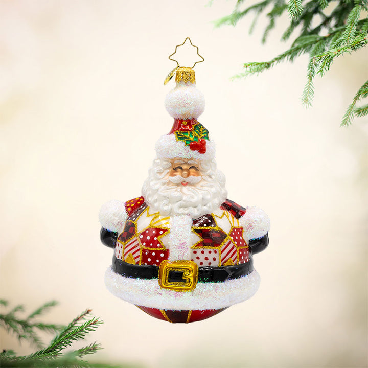 Quilted Jolly Claus ornament. Santa is dressed in a cozy patchwork quilt with shiny buttons and a festive hat. View of front. 