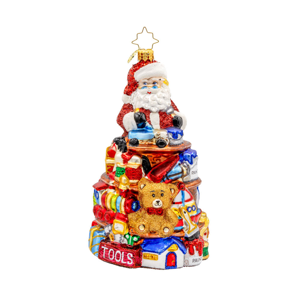 NorthPole Workshop Ornament. Santa atop a pile of toys. View of front.