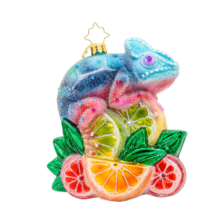 Camouflage Cutie ornament. A chameleon is perched on a vibrant pile of fruit. View of left side.