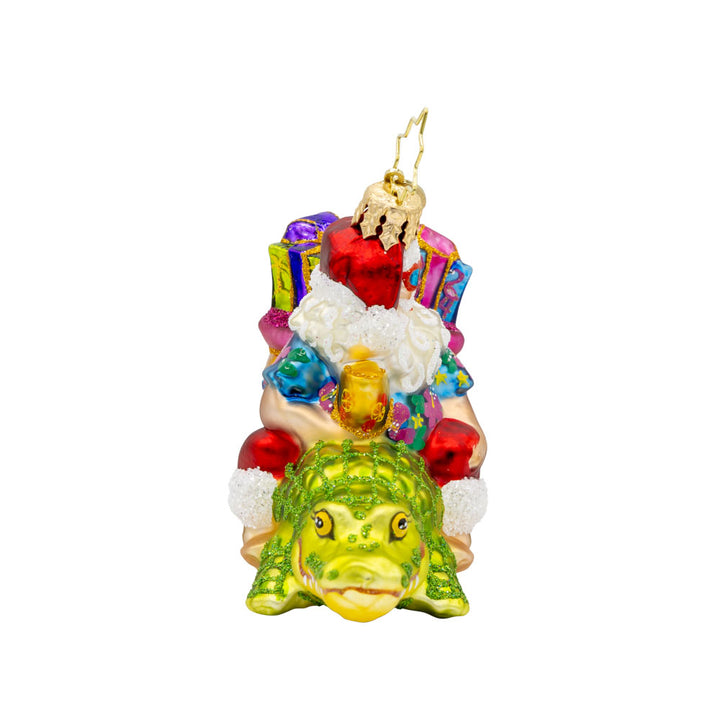 Sunshine State Gator ornament. Santa is trading in his sleigh for a gator and enjoying a tropical cocktail. "Florida" is written on gift sack. View of left side. 