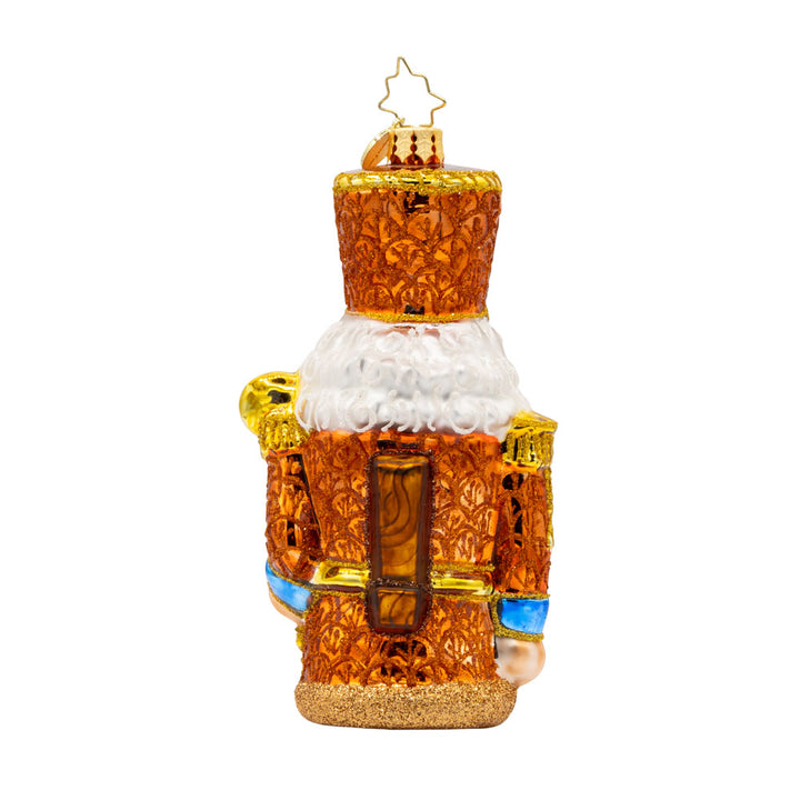 Gilded Guardian ornament. This nutcracker is donned in all gold with blue accents. View of back.
