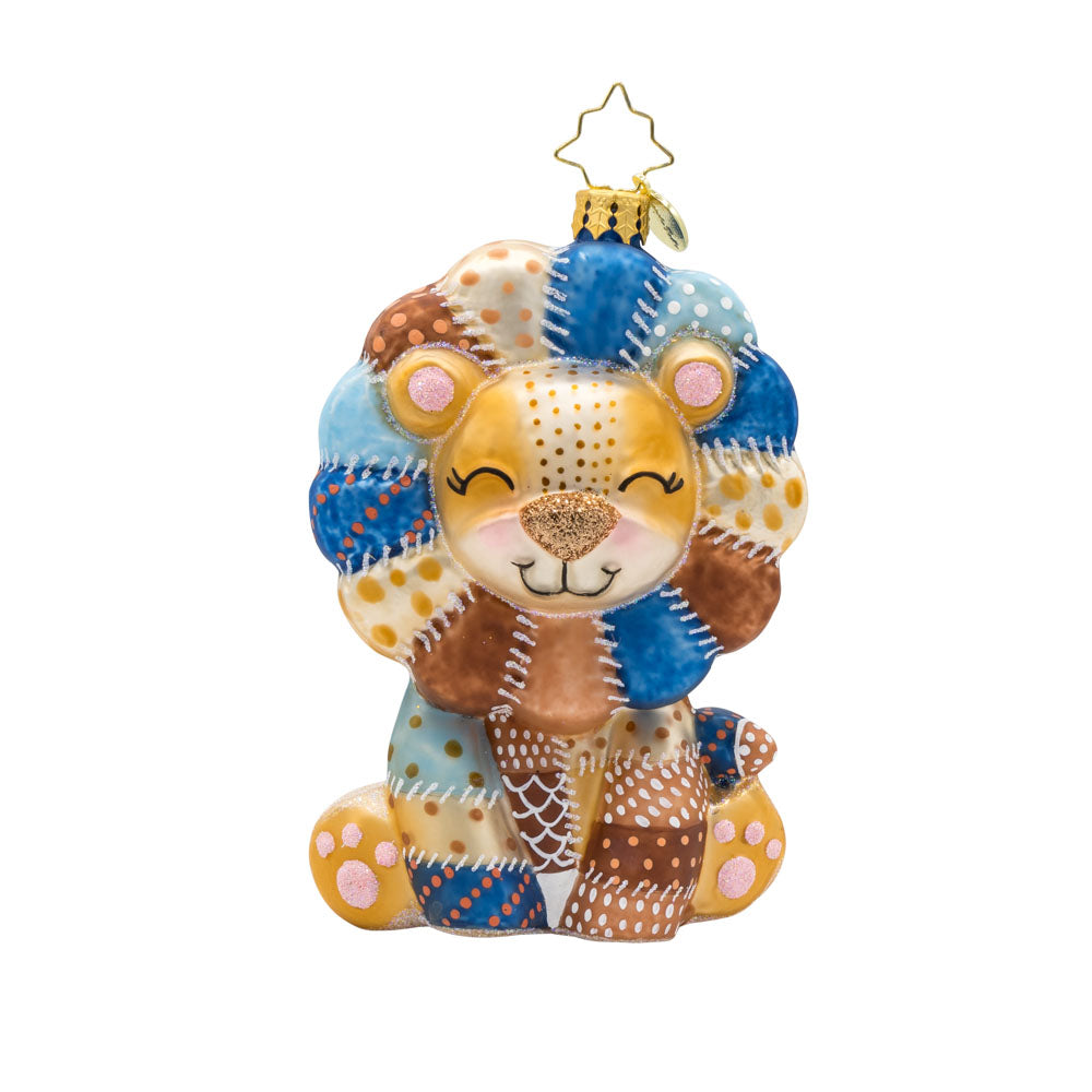 Patchy Paws ornament. This lion is made from beautifully detailed patches and topped with pink glitter accents. View of front. 