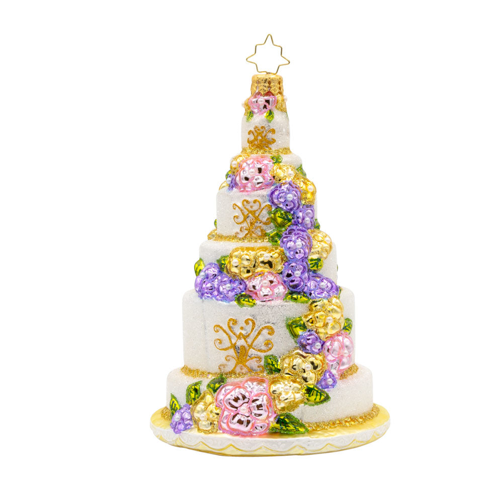 A Taste of Love ornament. An elegant wedding cake with an array of flowers and intricate designs. View of front.  