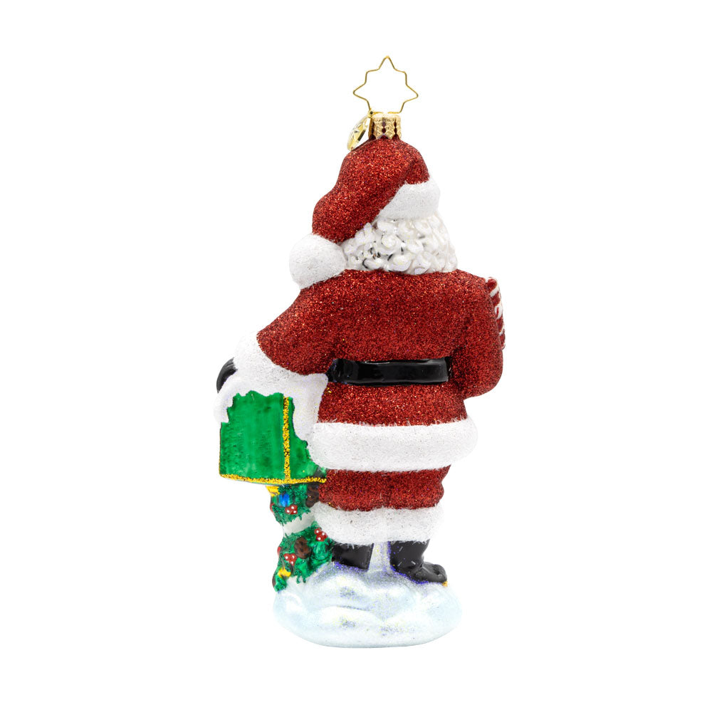 North Pole Mail Delivery ornament. Santa dons his red suit, standing next to a green mailbox filled with letters. View of back.