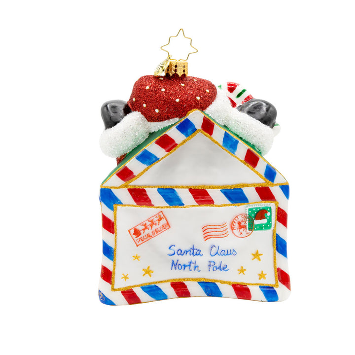 Letters To Santa ornament. Santa is featured here popping out of an envelope covered in gold stars, with a candy cane in his hand. View of back.