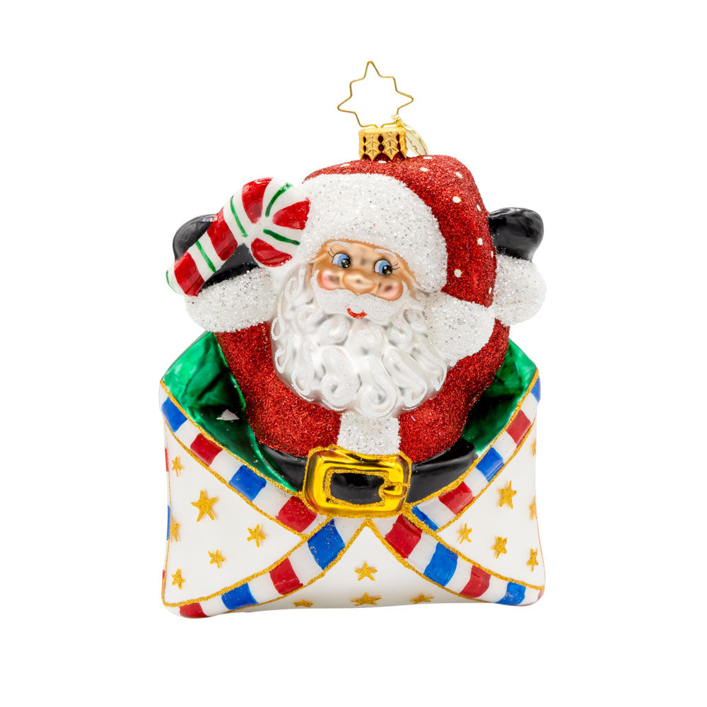 Letters To Santa ornament. Santa is featured here popping out of an envelope covered in gold stars, with a candy cane in his hand. View of front.
