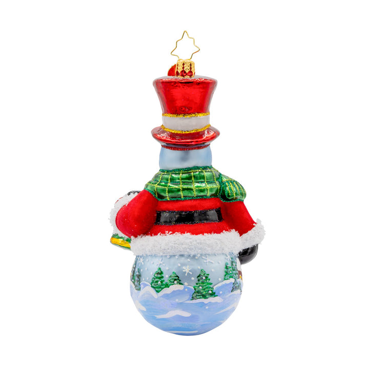 Snowy Sentinel ornament. From his shiny hat and pulled nose to his cozy scarf and festive bell. The hand-painted scene adds a touch of winter magic to this delightful ornament. View of back.