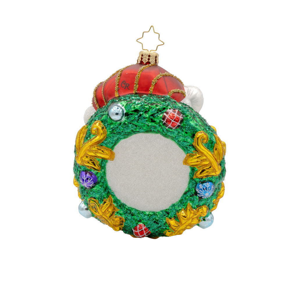Artic Majesty ornament.  This polar bear is adorned with a festive wreath, sparkling gems, and a shiny red hat. View on back.