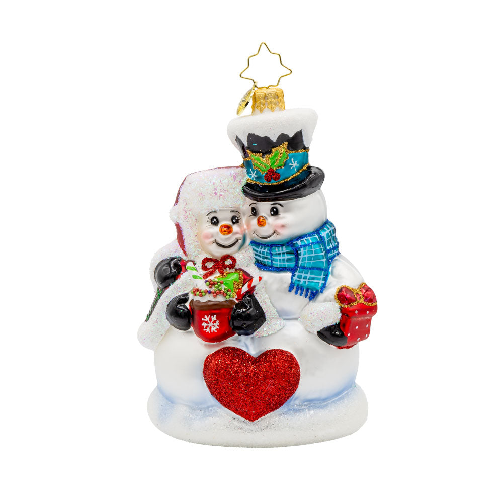 Winter Lovebirds ornament. A lady and gentleman snowman cuddle up with a cup of hot cocoa. View of front. 