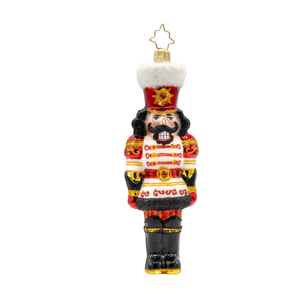 Gemstone Guardian ornament. This nutcracker wears a satin white jacket adorned with red gems and shiny black boots. View of front. 