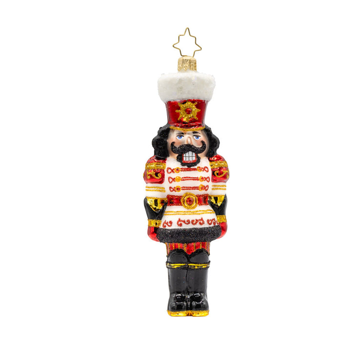 Gemstone Guardian ornament. This nutcracker wears a satin white jacket adorned with red gems and shiny black boots. View of front. 