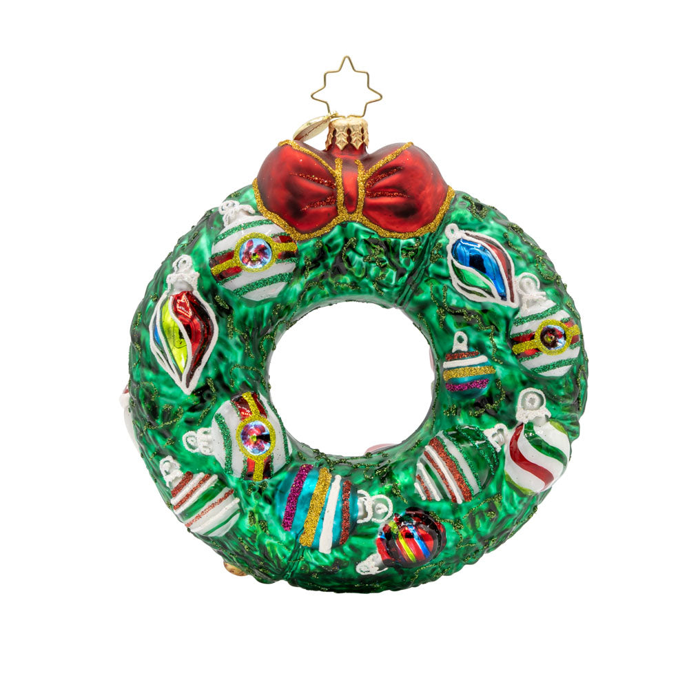 This wreath ornament features a delightful cast, from Santa and his reindeer to a playful snowman and a charming gingerbread man. View of back.