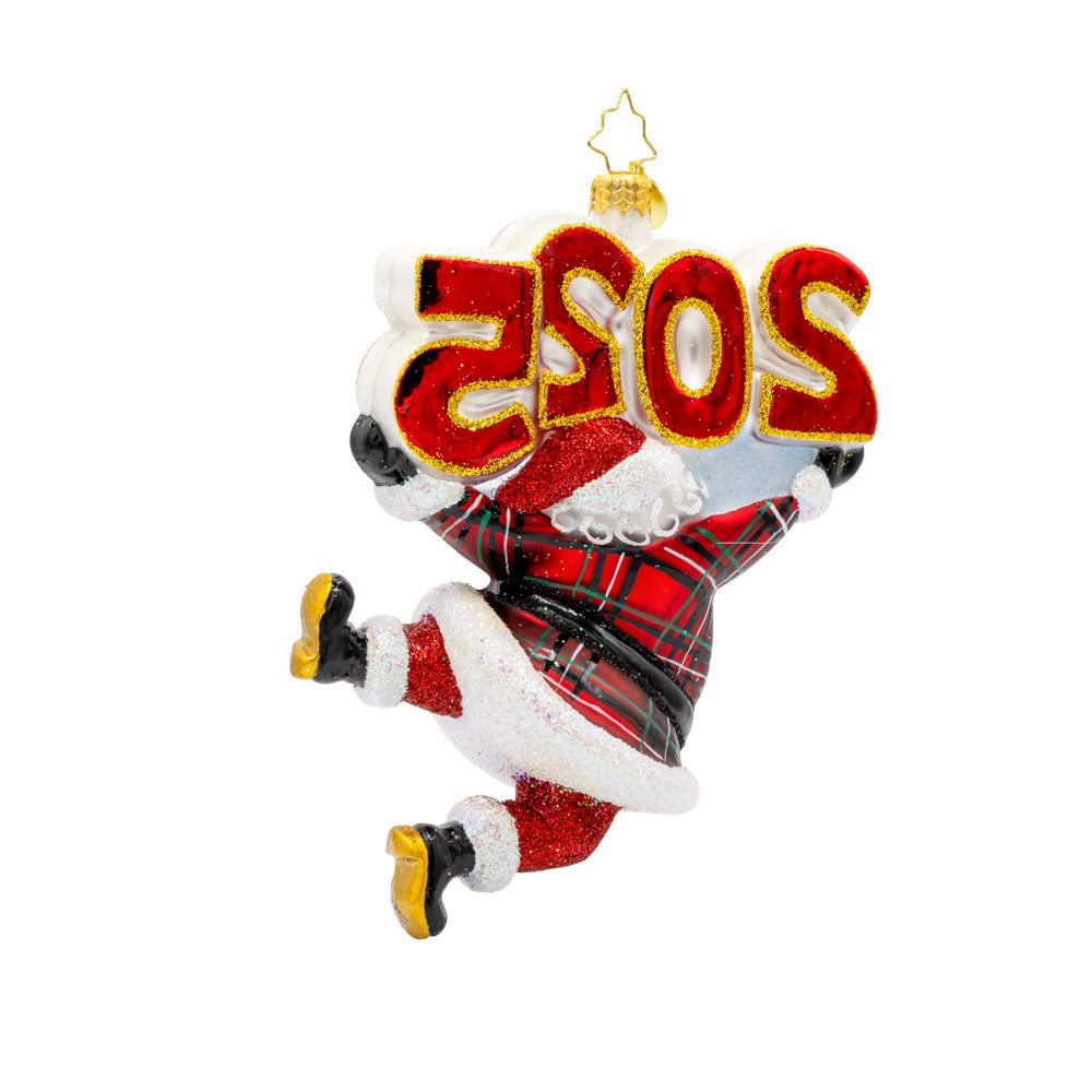 Tartan Time For Fun Ornament. Santa is dressed in a plaid suit, complete with a shiny hat, mittens, and a touch of glitter. "2025" is held above his head in similar colors. View of back.