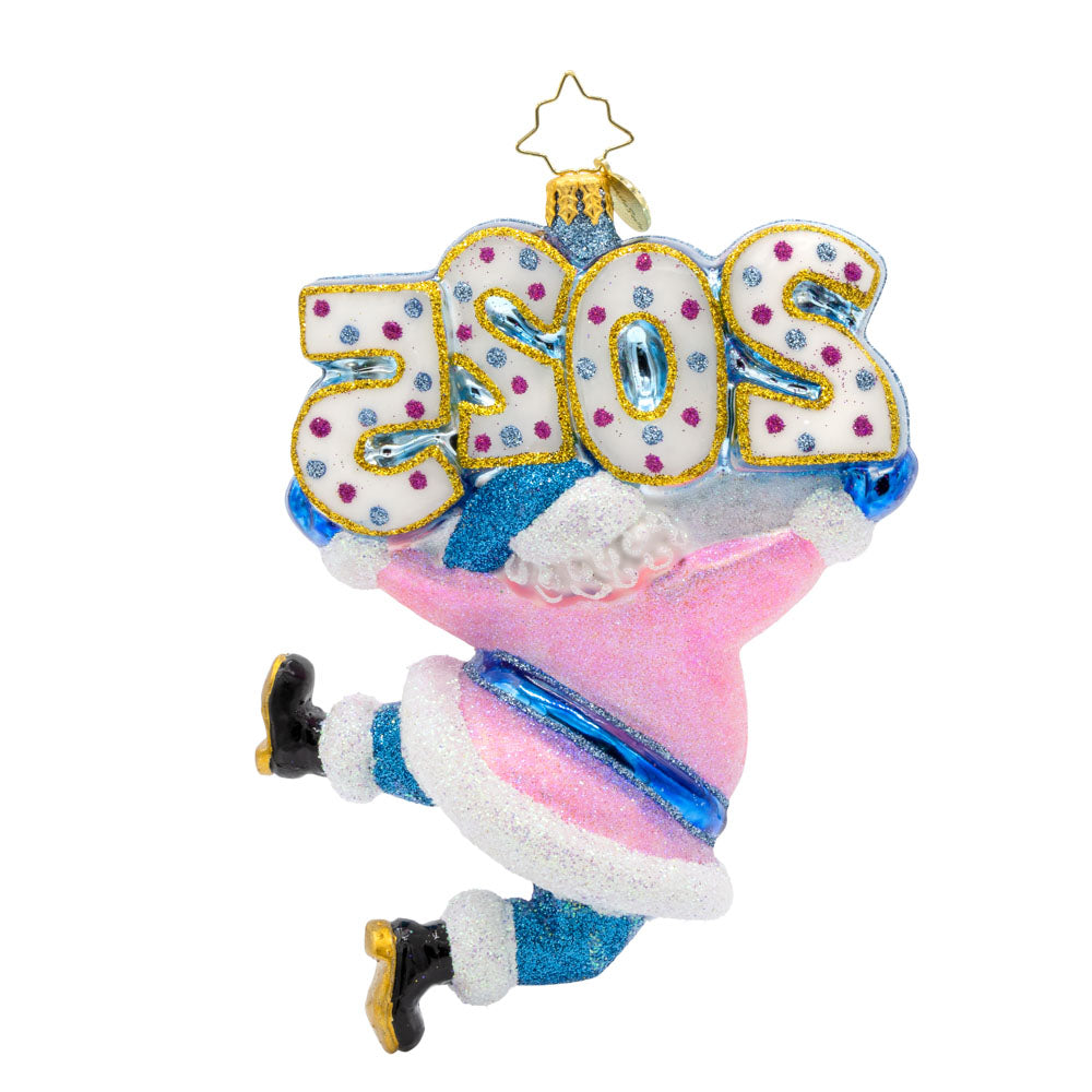 Jingle Bell Jamboree Ornament. Santa's rocking a dazzling outfit with glittering accents and a splash of pink. "2025" is held above his head in similar colors. View of back.