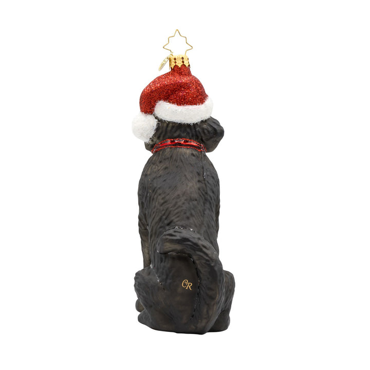 Loyal Lab ornament. A black dog with a Santa hat perched atop their head. View of back.