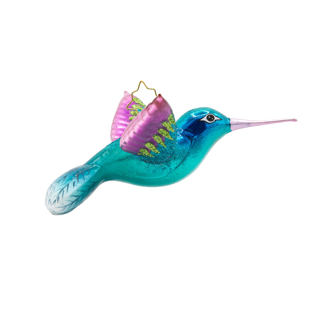 This Hummingbird Christmas ornament showcases a dazzling hummingbird with iridescent blue and fuchsia plumage. View of left side.