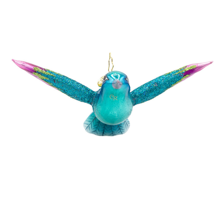 This Hummingbird Christmas ornament showcases a dazzling hummingbird with iridescent blue and fuchsia plumage. View of front.