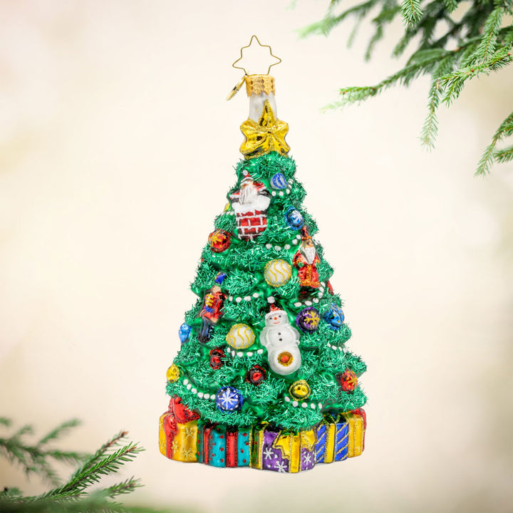 A Tree of Holiday Traditions Ornament with its shimmering ornaments and festive details. View of front. 