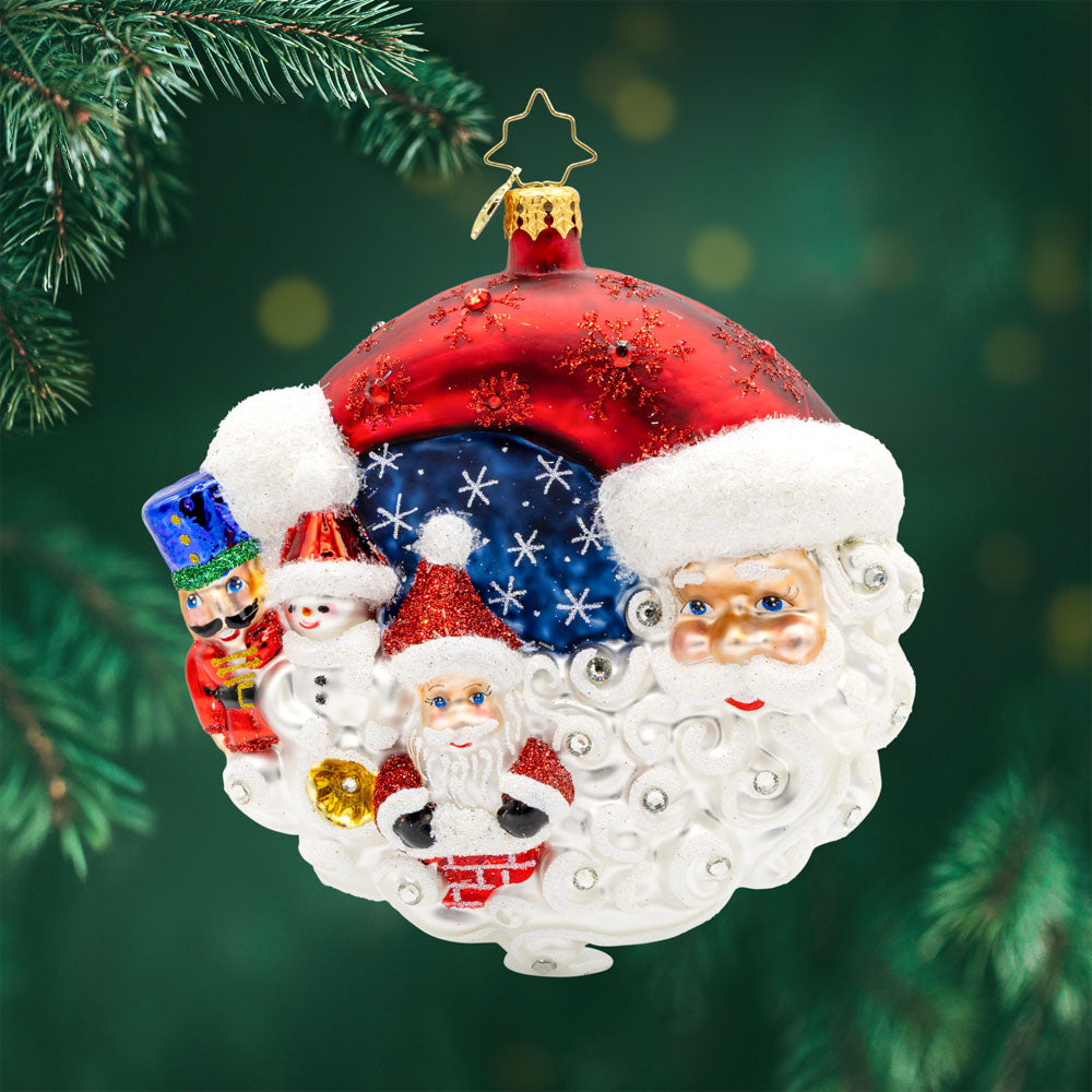 A Merry Little Christmas ornament. Santa, joined by his trusty companions - a cheerful snowman and a dapper nutcracker - Santa's face reimagined as a half-moon shapes the scene into a festive decorated round. View of front. 