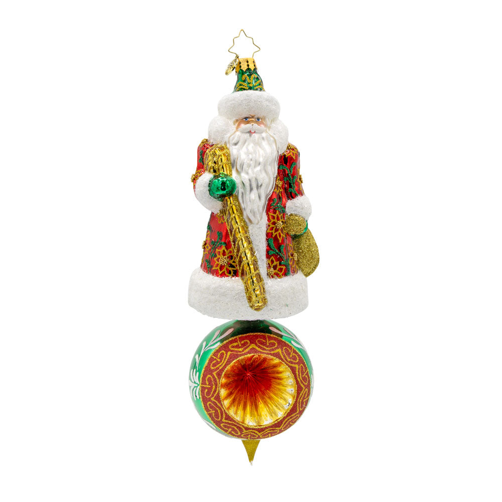 Regal Reflections Ornament. Santa, dressed in his finest attire, stands tall and proud, surrounded by a delightful array of festive motifs. View of front.