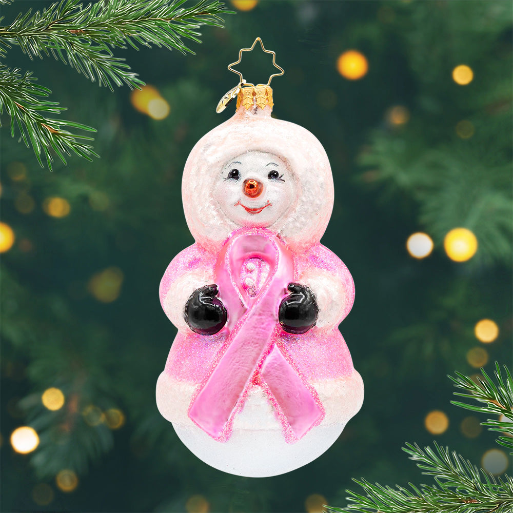 Ribbon of Winter Wishes. Snowman ornament dressed in a pink robe and holding a pink ribbon for breast cancer awareness. View of front