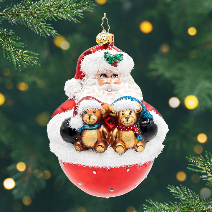 Bearing Holiday Cheer. Ornament of Santa holding to brown teddy bears with a round base. View of front
