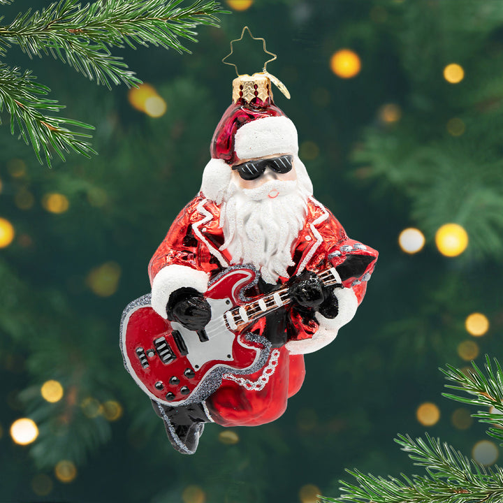 Jingle Bell Rocker. Ornament of Santa in a red rocker star outfit and play a red and silver guitar. View of front
