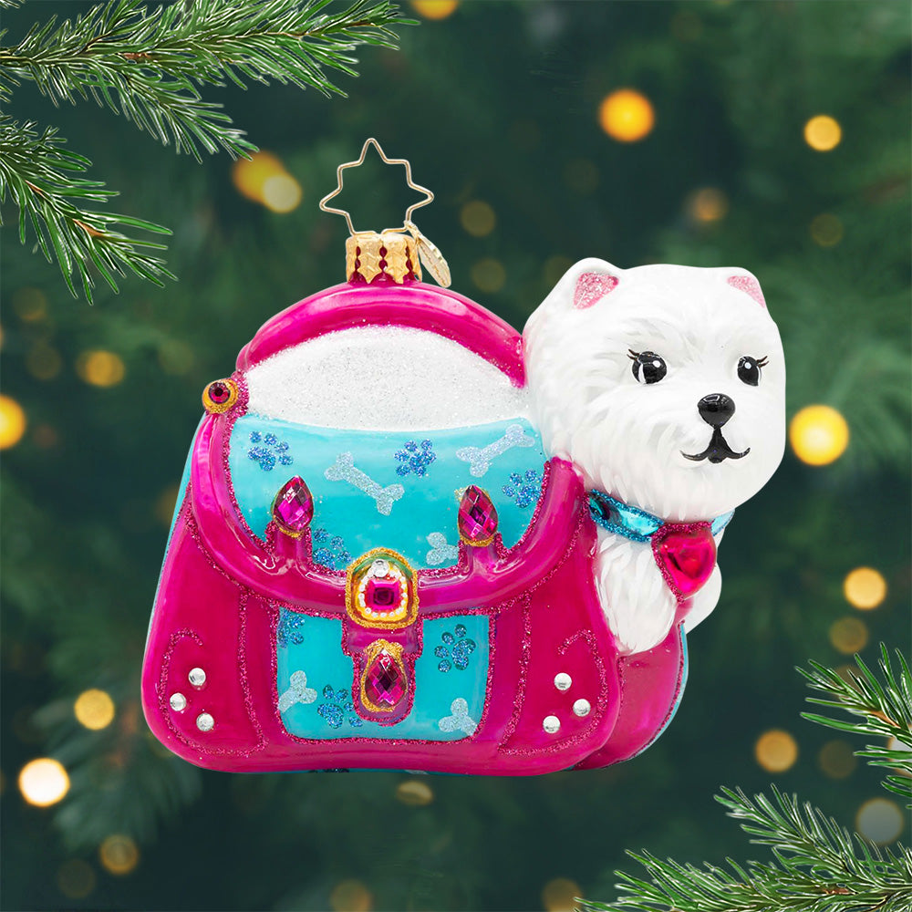 Puppy Parcel. Ornament of a white dog in a pink sparkly purse. View of front.