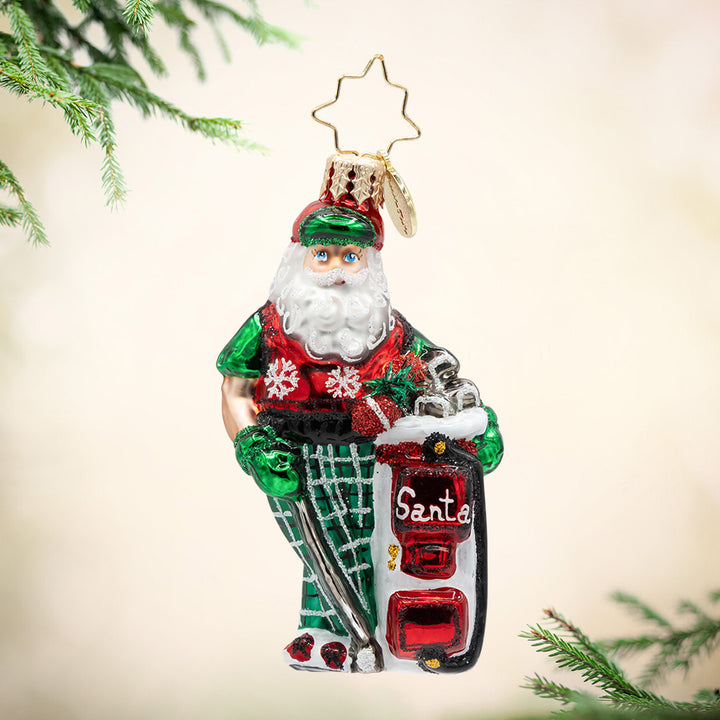 Jolly Golfer Santa Gem. Ornament of Santa in a red and green golf outfit next to a white gold bag with red detailing and the word "Santa."