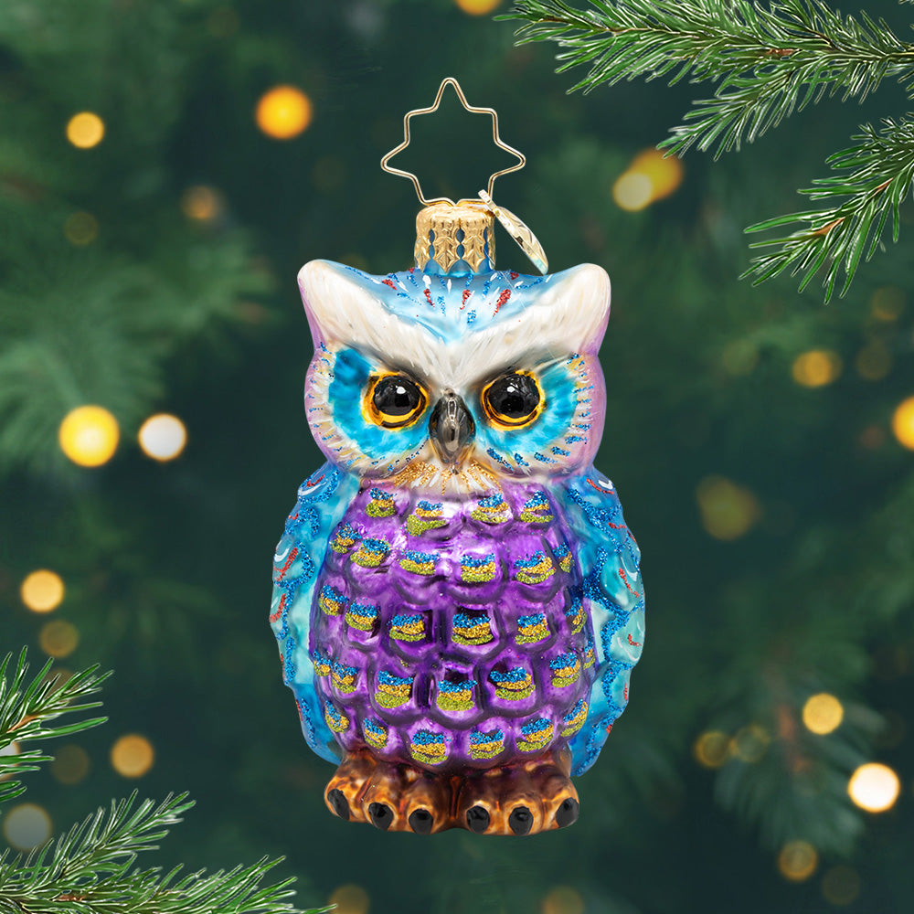 Regal Feathered Friend Gem. Ornament of a Blue and purple owl with glitter detailing's in blue and gold. View of front.