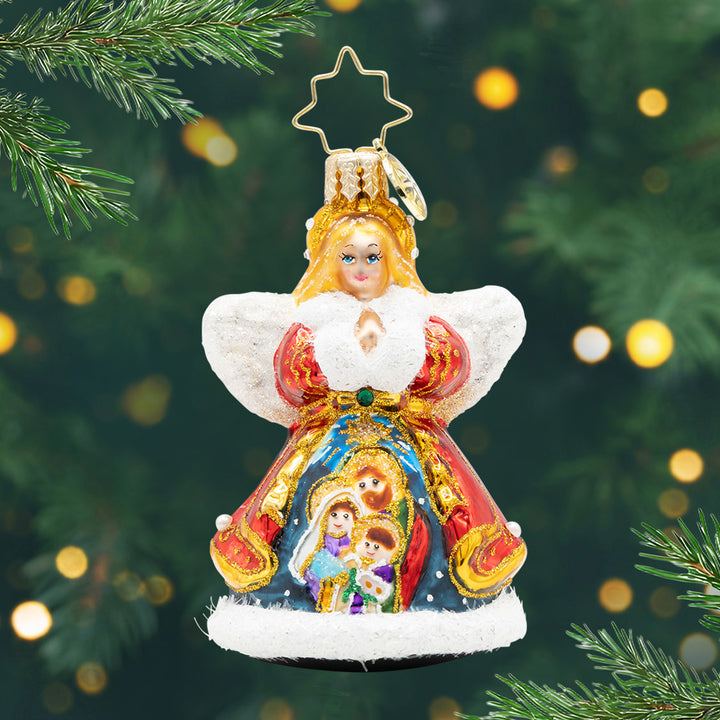 Nativity Guardian Gem. An Angel ornament dressed in a red and gold detailed coat with a nativity scene painted in the front. View of front