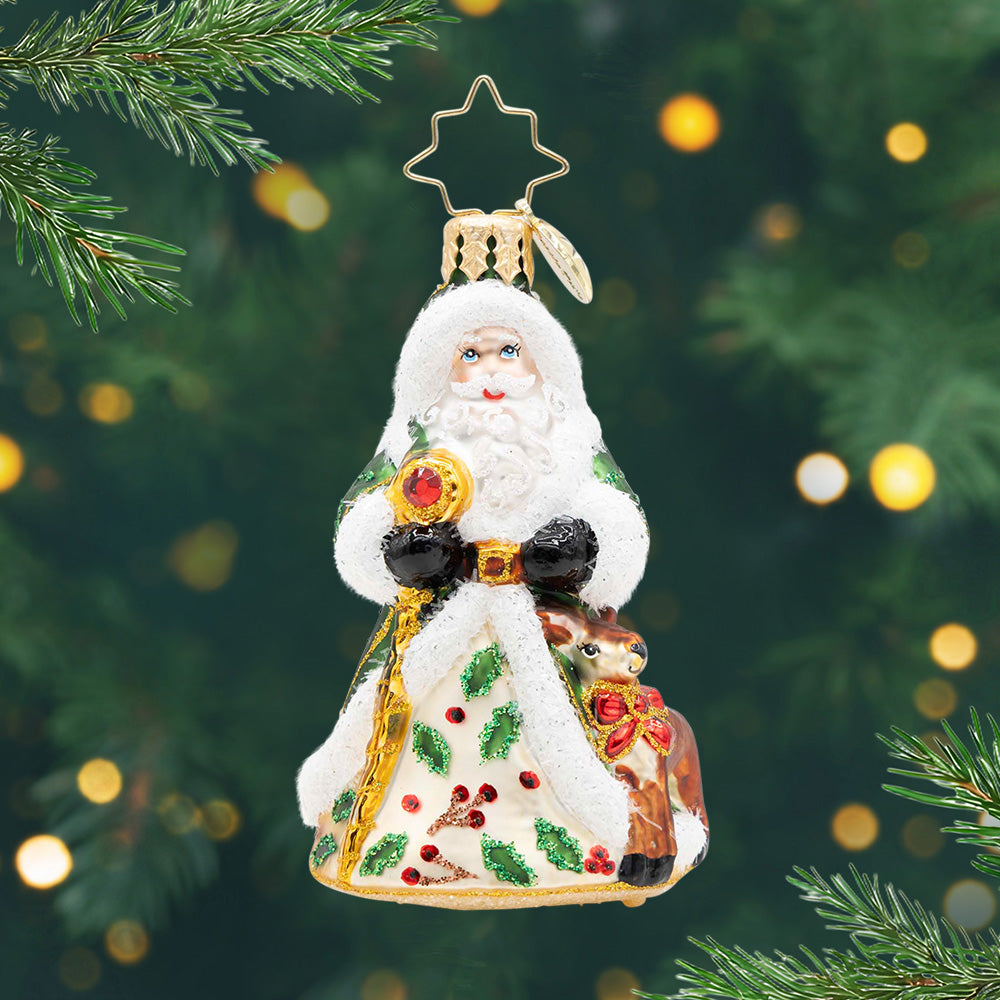 Deerly Beloved Santa Gem. Ornament of Santa in a green robe with mistletoes in the front, a dear next to him, and holding a gold staff. View of front