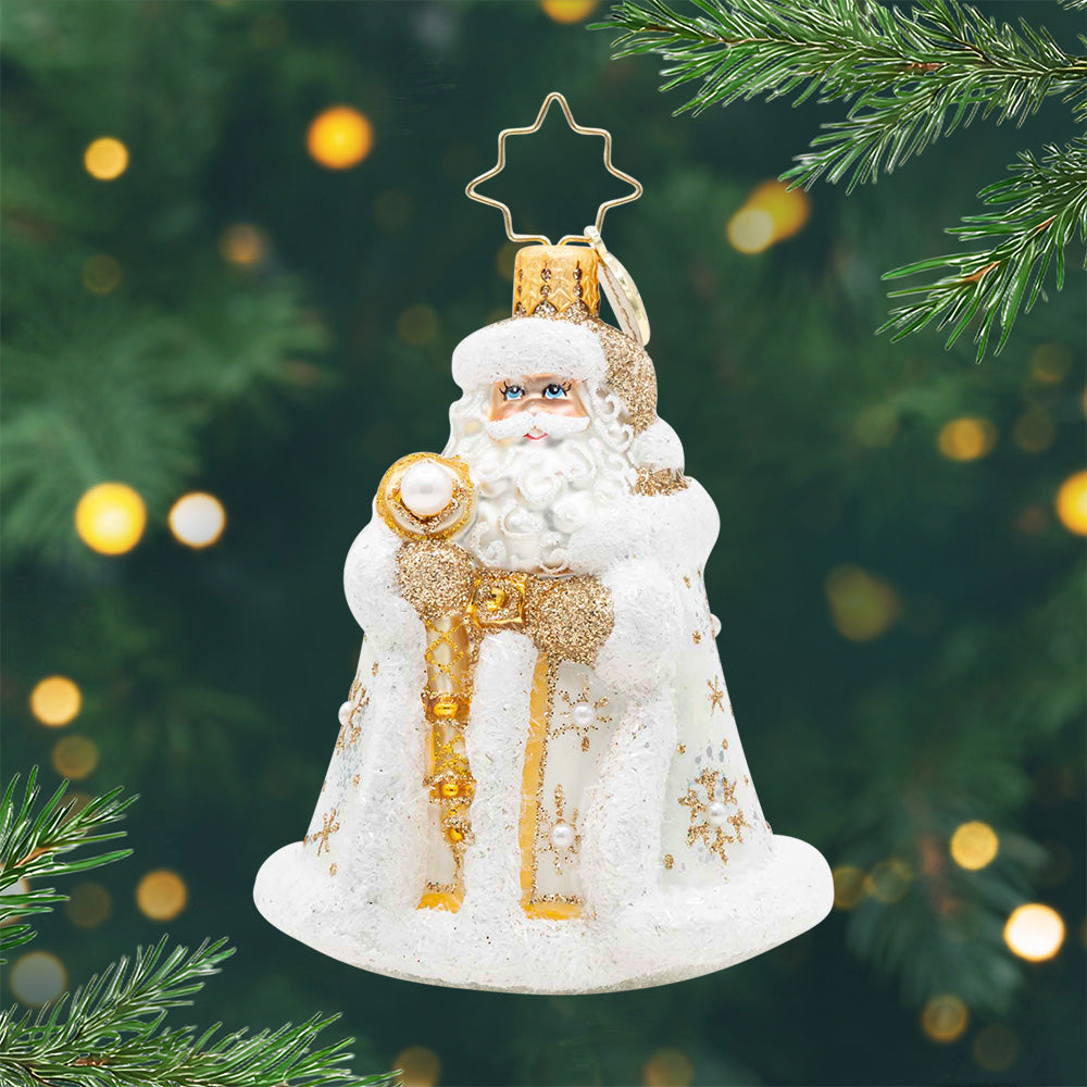 Gilded Kris Kringle Gem. Ornament of Santa in a white robe robe with gold detailing while holding a gold staff. View of front