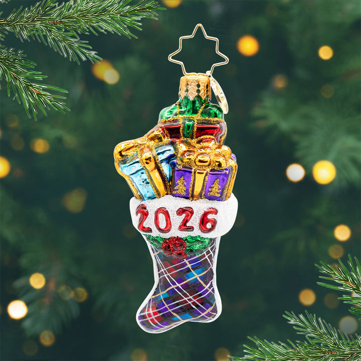 2026 Stacked Holiday Joy Gem. Stocking ornament with a striped pattern in colors of blue purple., and red with presents popping out and the year 2026 in red. View of front