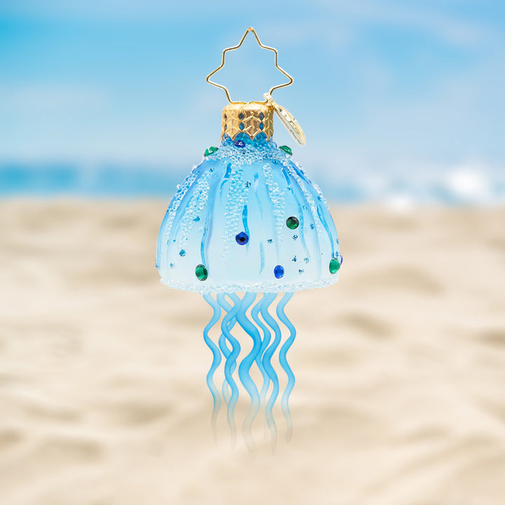 Aqua Moon Jelly Gem. Ornament of a light blue jellyfish with gems. View of front