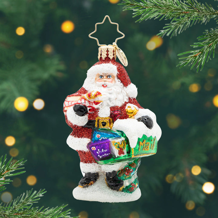 North Pole Mail Delivery Gem. Ornament of Santa in his sparkly red suit next to a green mailbox filled with letters. View of front