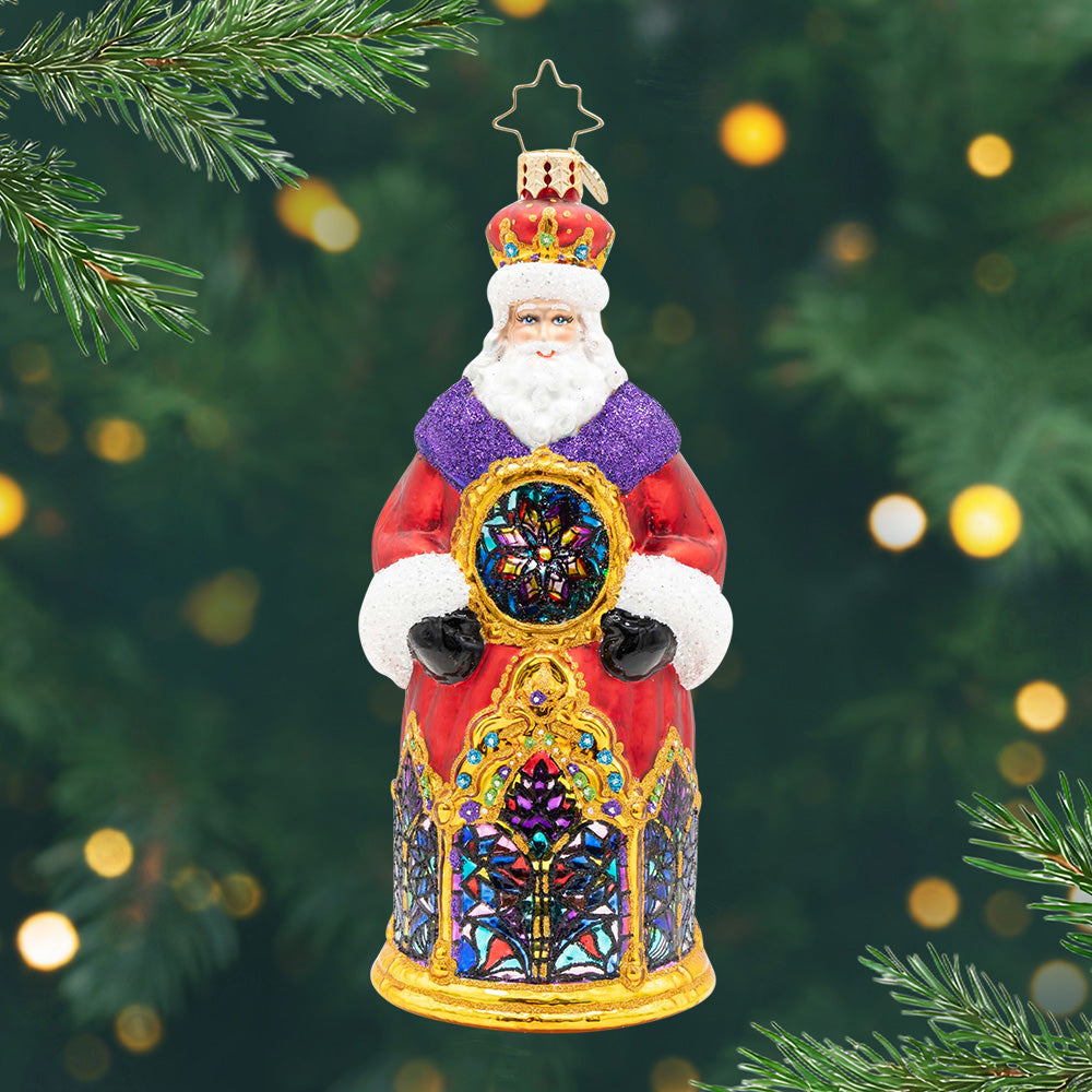 Holy Night Reflections. Santa ornament of him in a red robe with purple and gold details along with cathedral glass-stained windows on the front. View of front