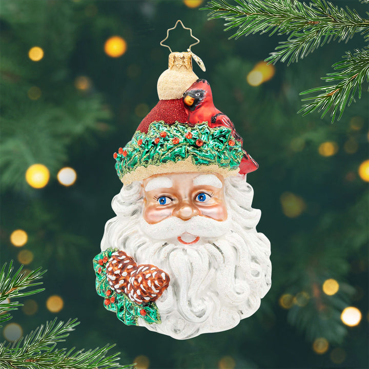 Woodland Wishes Santa. Ornament of Santa's head with pinecones and a red cardinal on his hat. View of front.