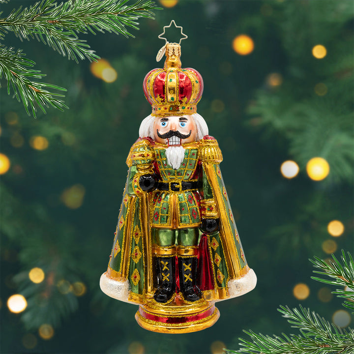The Gilded Sentinel. Nutcracker ornament in colors of green and gold and a red crown. View of front.