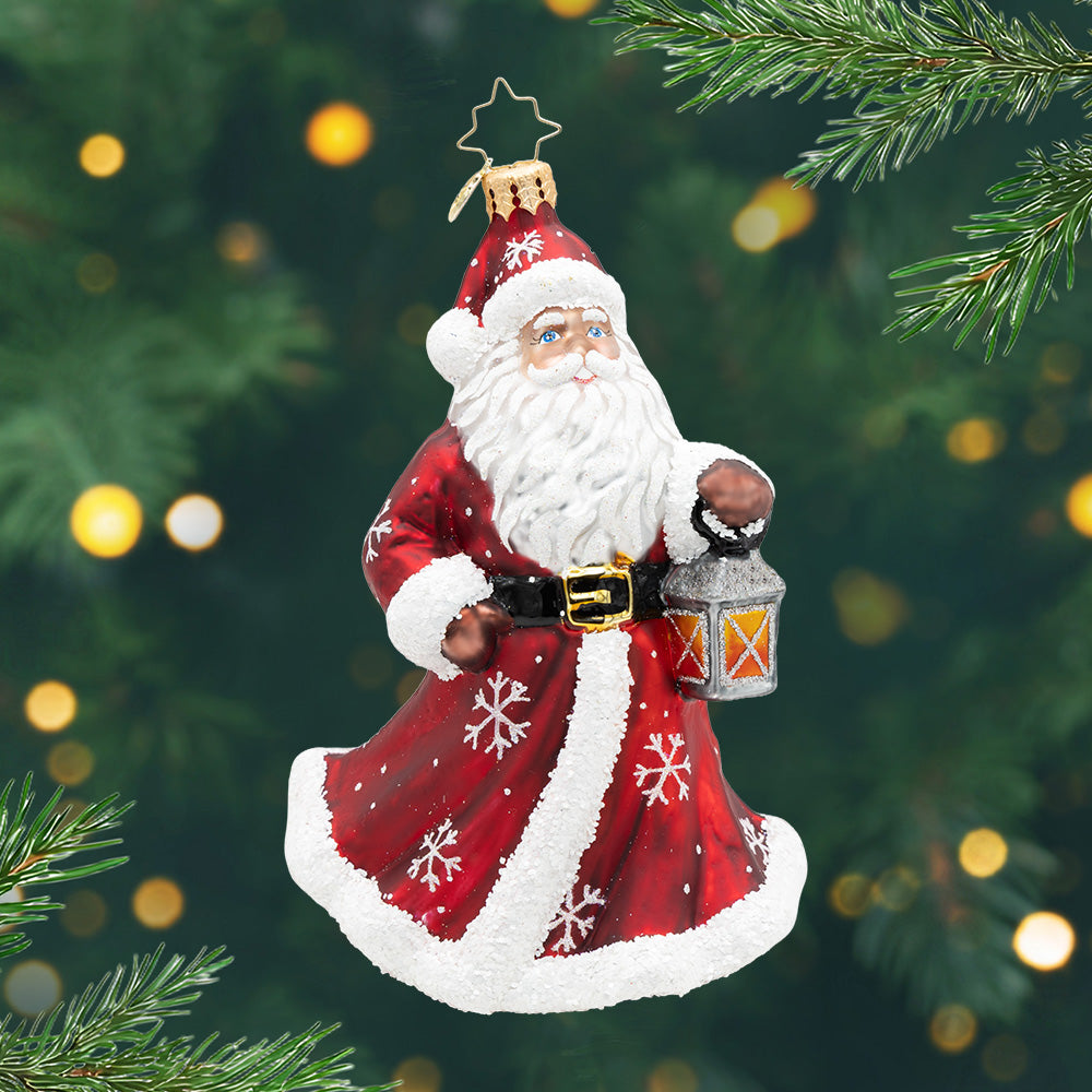 Yuletide Wanderer. Ornament of Santa in a red robe carrying a silver lantern. View of front