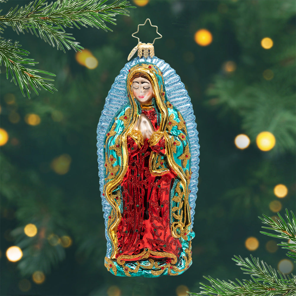 Blessed Mother Divine. Ornament of Mary wrapped robe of emerald and crimson with shimmering gold accents, surrounded by a radiant halo of sparkling light blue. View of front