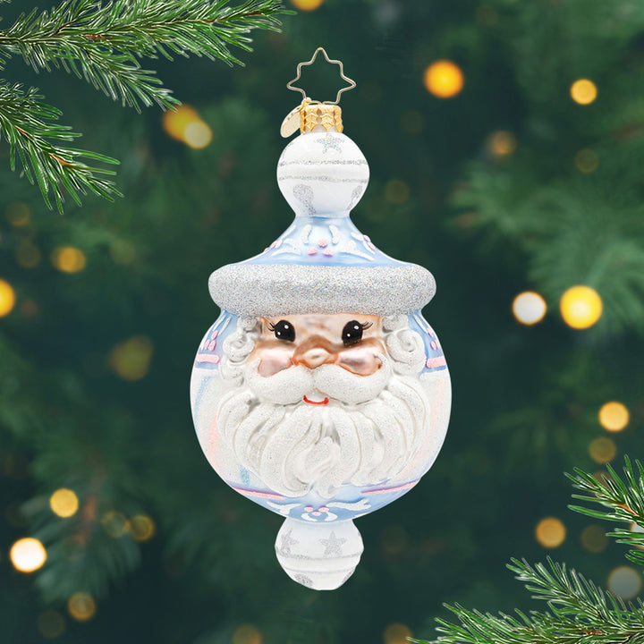 Charming Chimes Claus. A white, silver, and light blue round ornament with Santa's face in the front and a white bell at the top and the bottom. View of front.