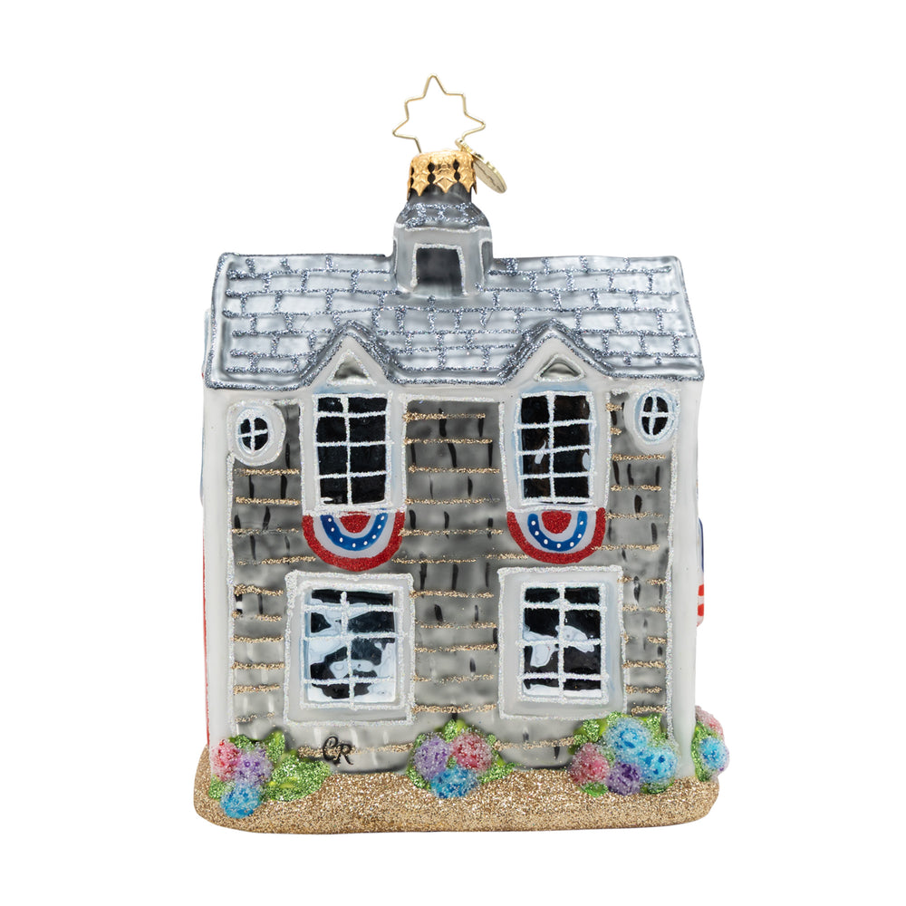Decorative house ornament with flags and flowers on a white background